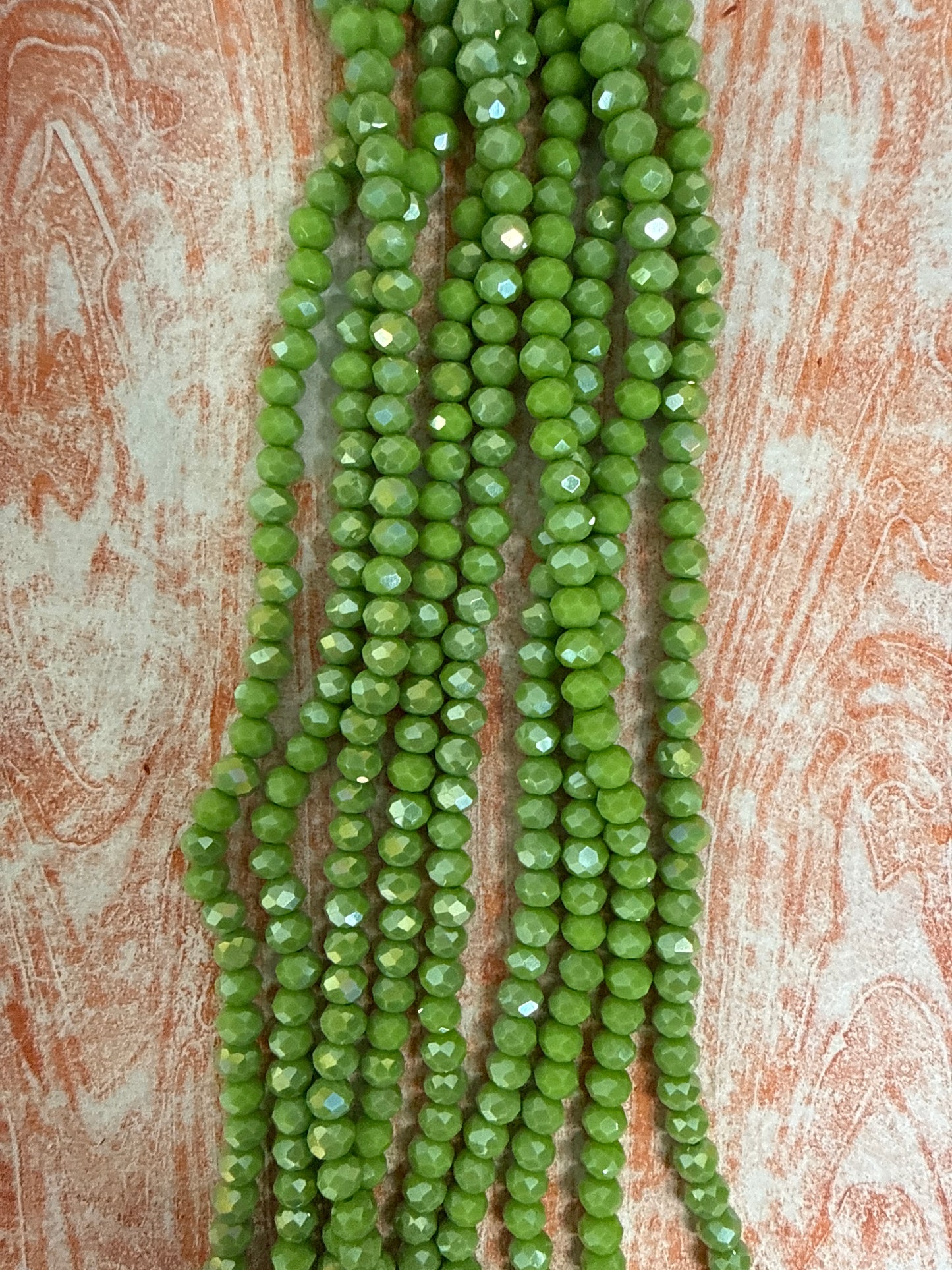 GLASS RONDELLE 6MM OLIVE OPAQUE AB 1 STRAND