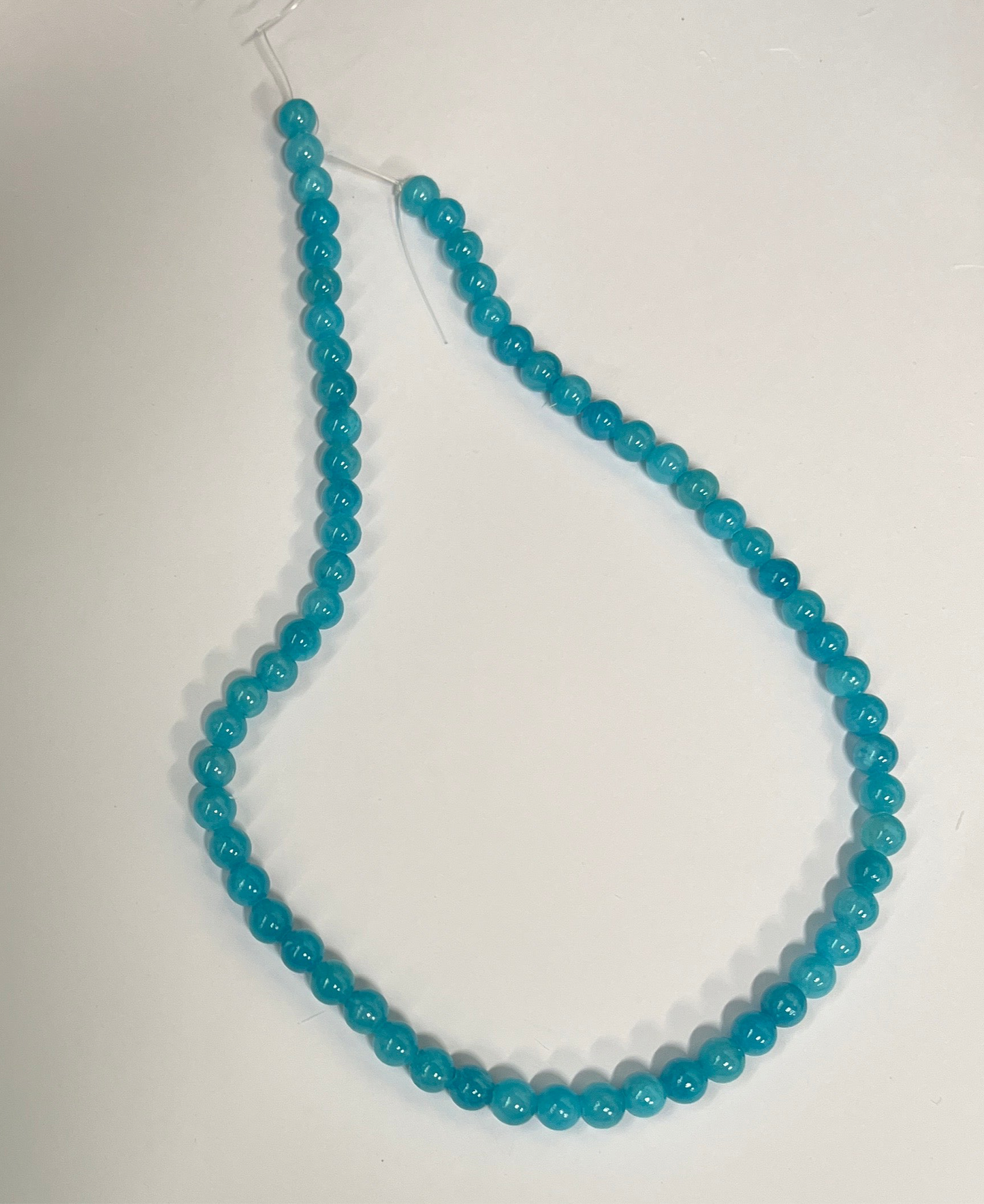 YELLOW JADE 6MM ROUND DODGER BLUE 1 STRAND