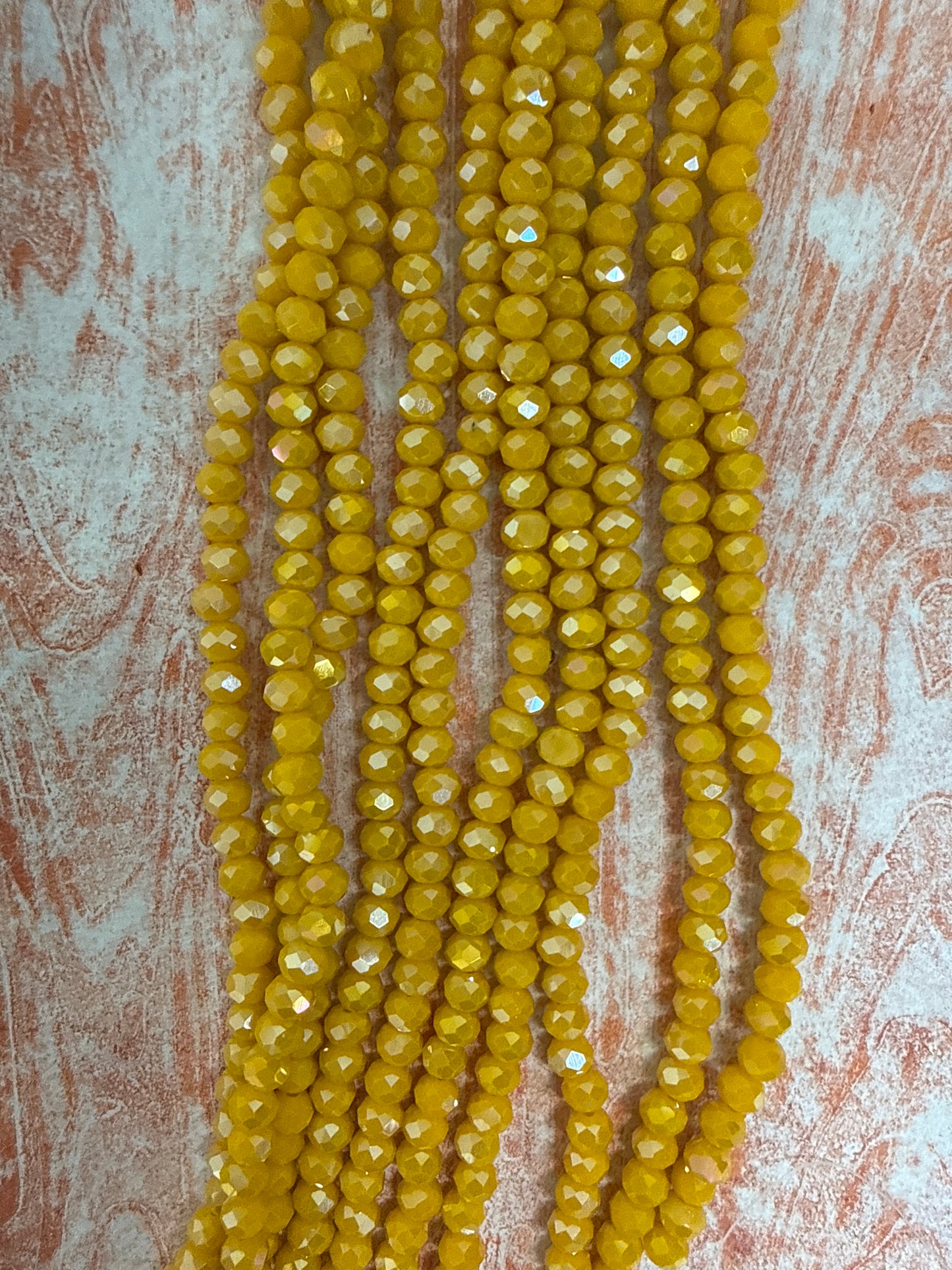 GLASS RONDELLE 6 MM GOLD OPAQUE AB 1 STRAND