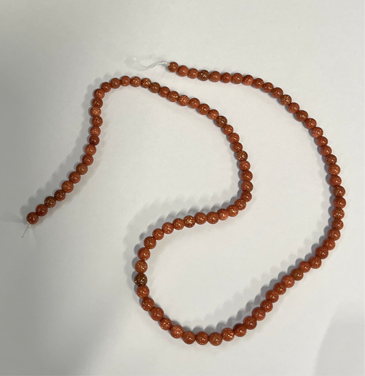 GOLDSTONE 4MM ROUND 1 STRAND