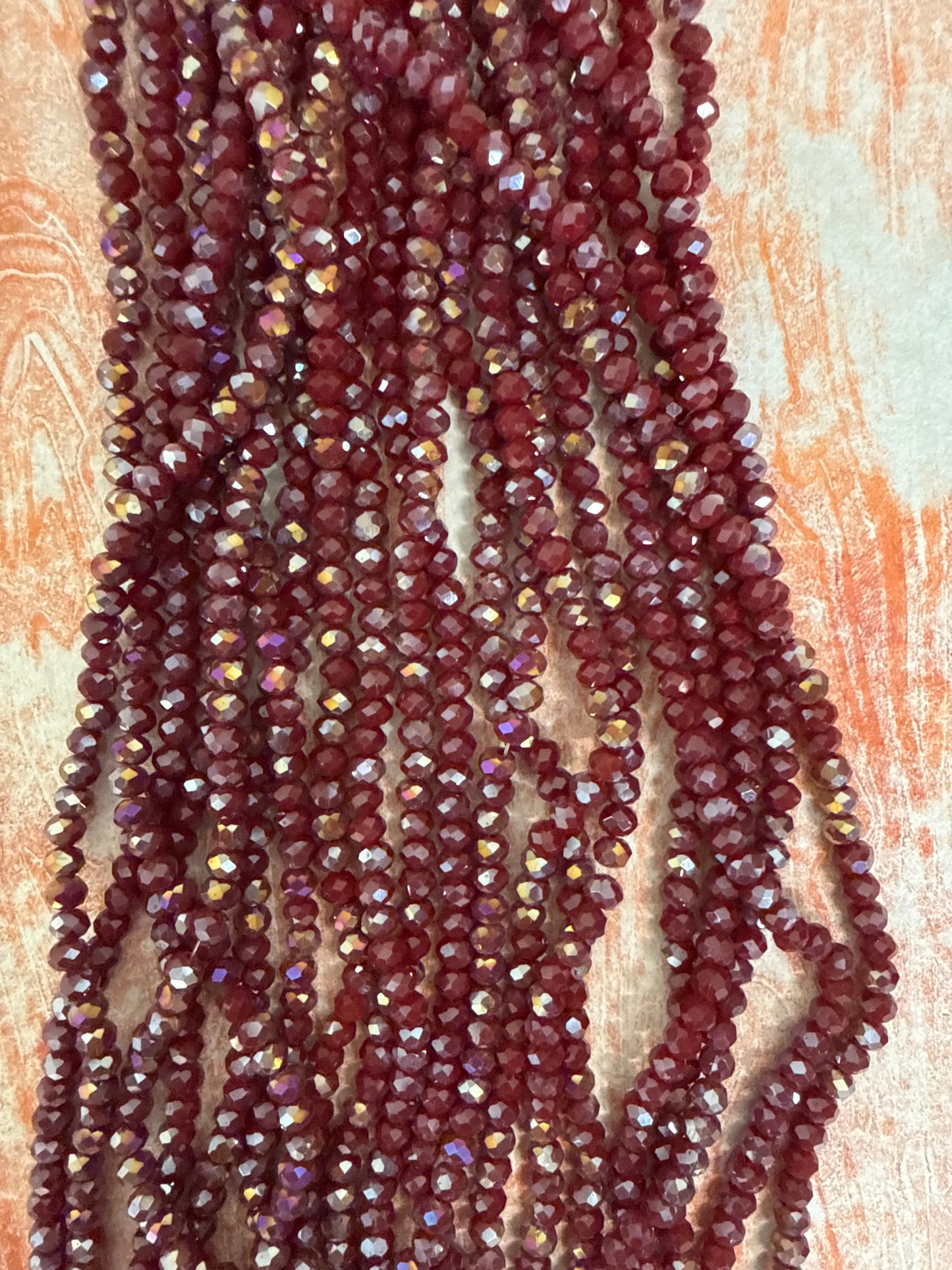 GLASS RONDELLE 6MM BURGUNDY OPAQUE AB 1 STRAND