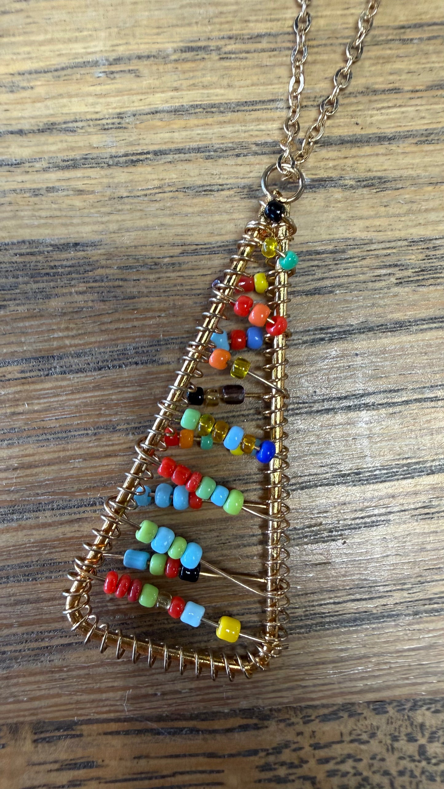 Necklace chain with triangle pendant with multicolor seed beads.