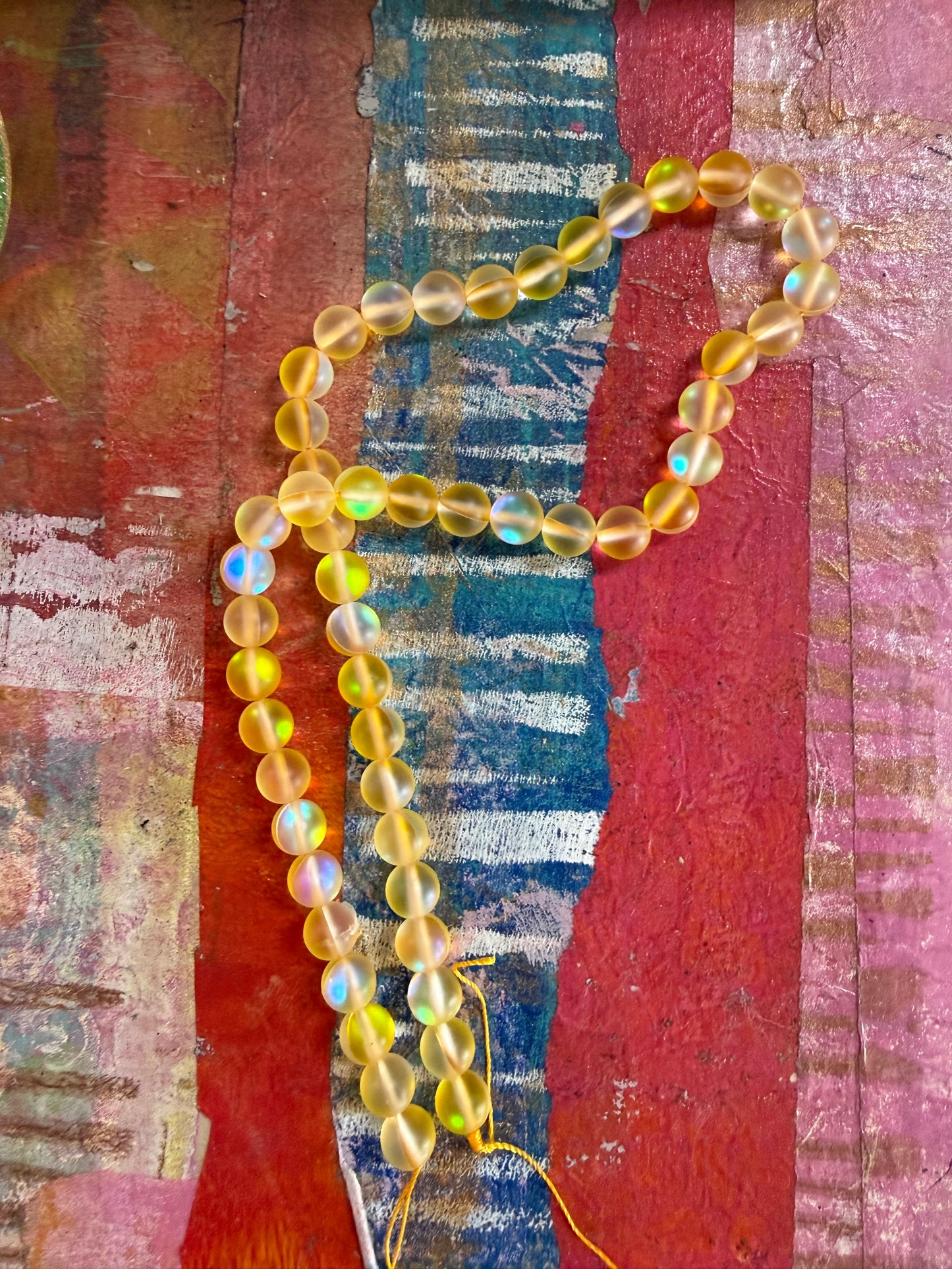 Mermaid glass 8mm round yellow ab 1 strand
