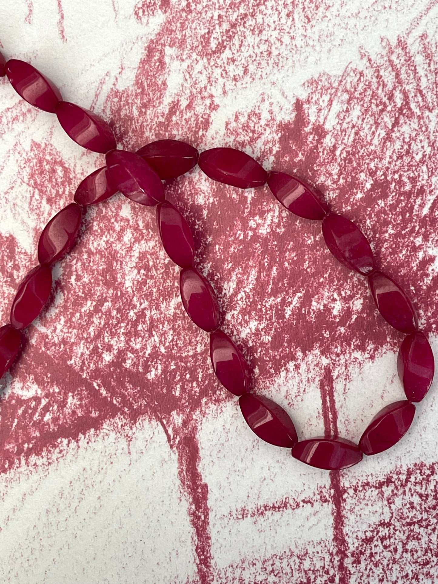 JADE 18X8MM TWIST OVAL CRIMSON 1 STRAND