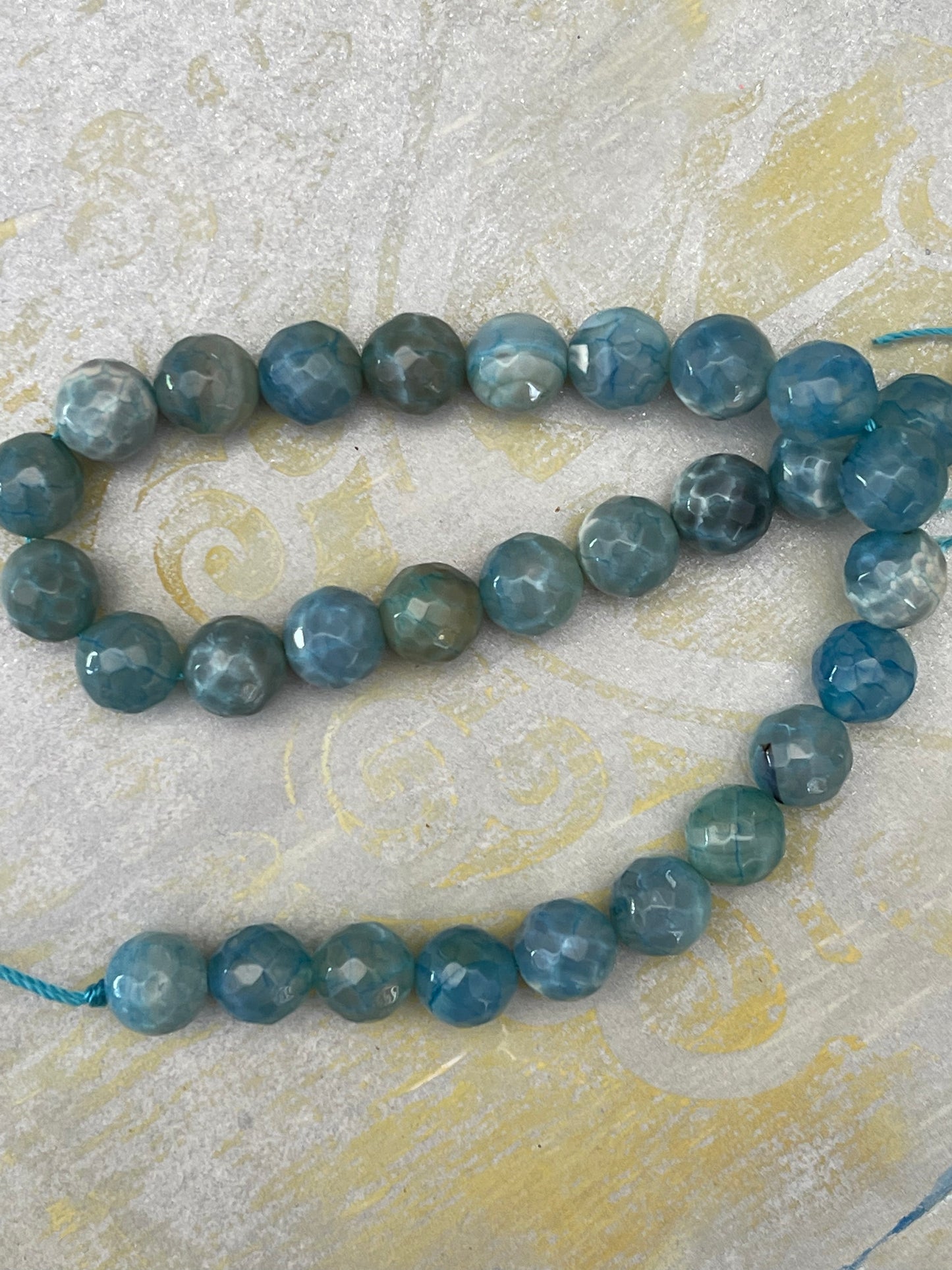 FIRE CRACKLE AGATE ROUND FACETED ACQUA 1STRAND