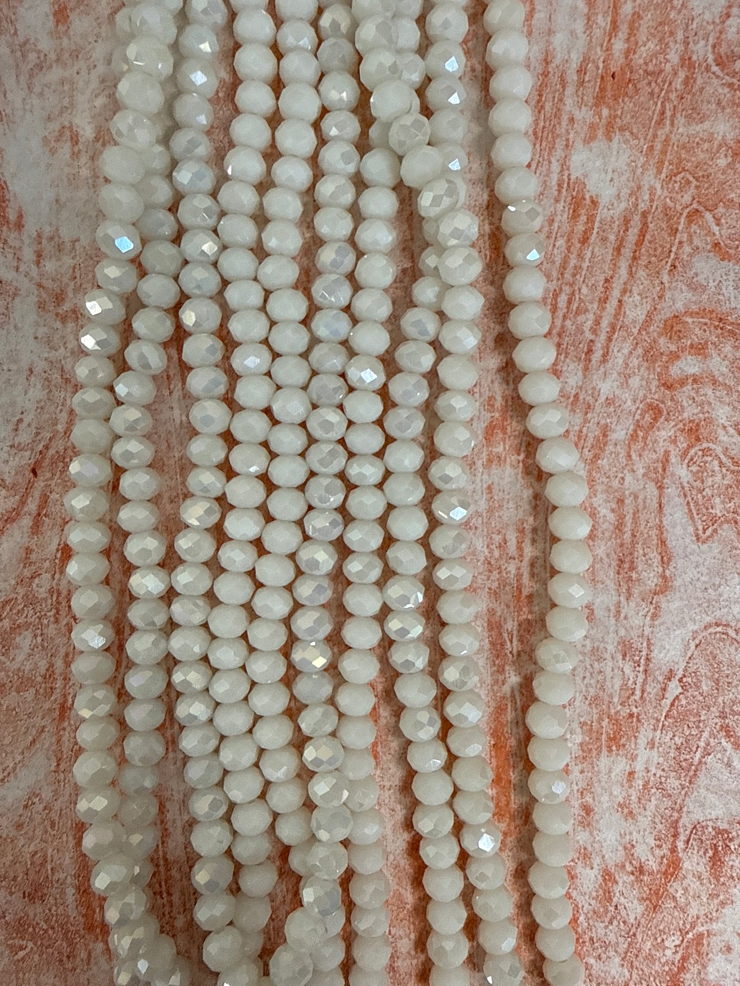 GLASS RONDELLE 6MM WHITE OPAQUE AB 1 STRAND