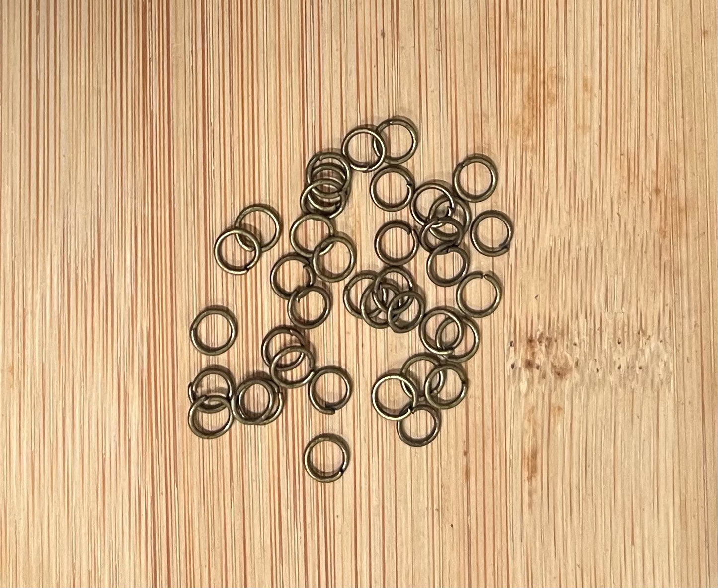 JUMPRING 5MM 21GA ANT BRONZE  25 PC APROX