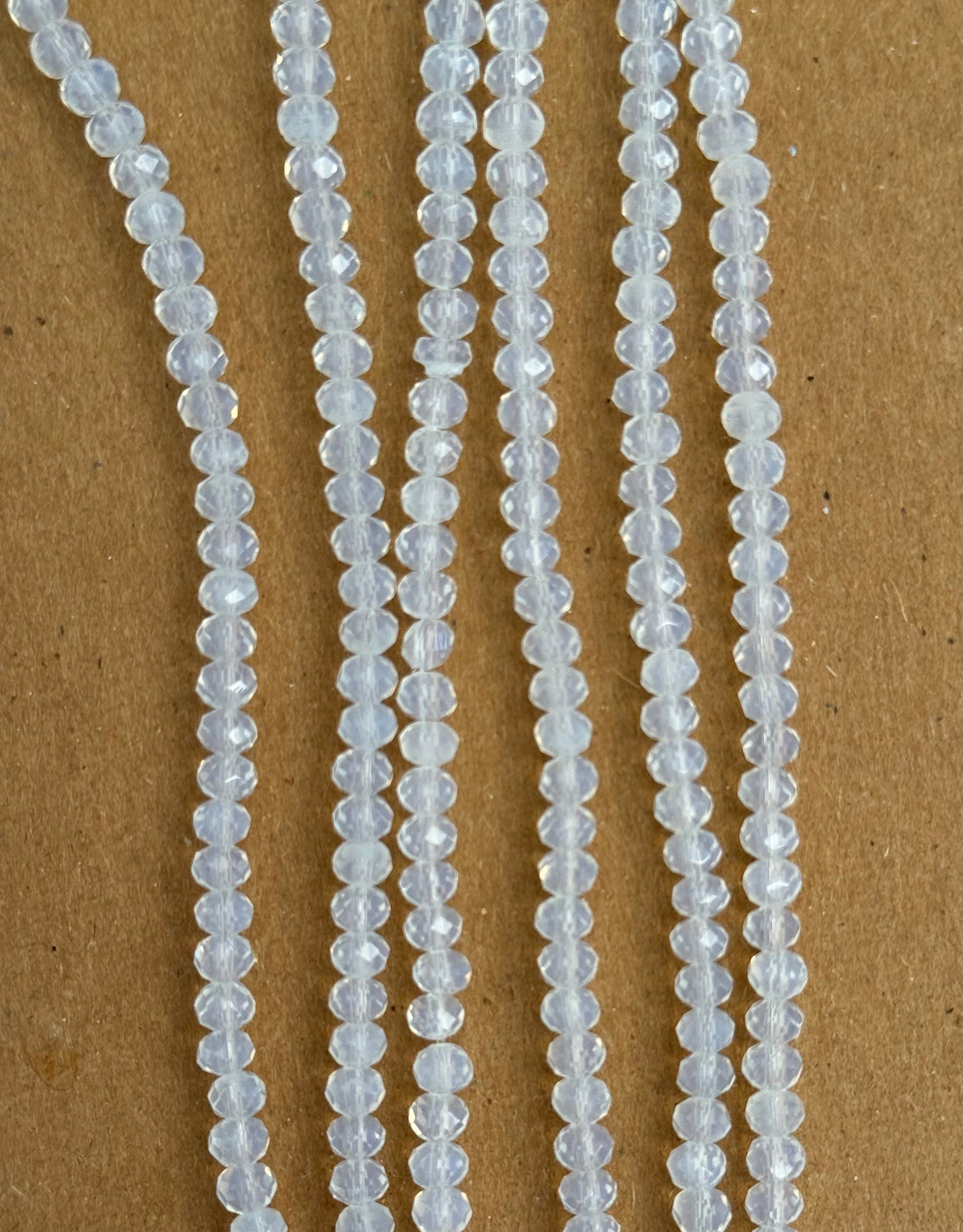 GLASS RONDELLE 4X3MM CLEAR OPAQUE 1 STRAND