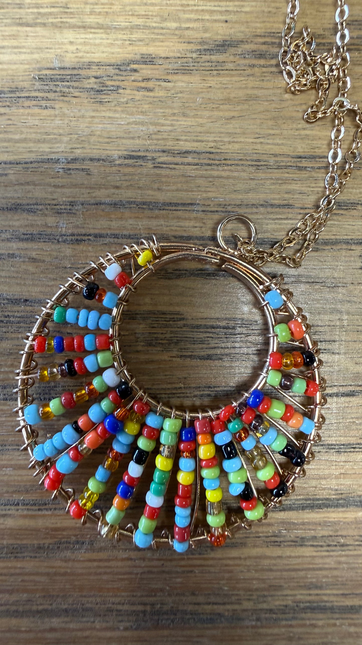 Necklace chain with circle pendant with multicolor seed beads.