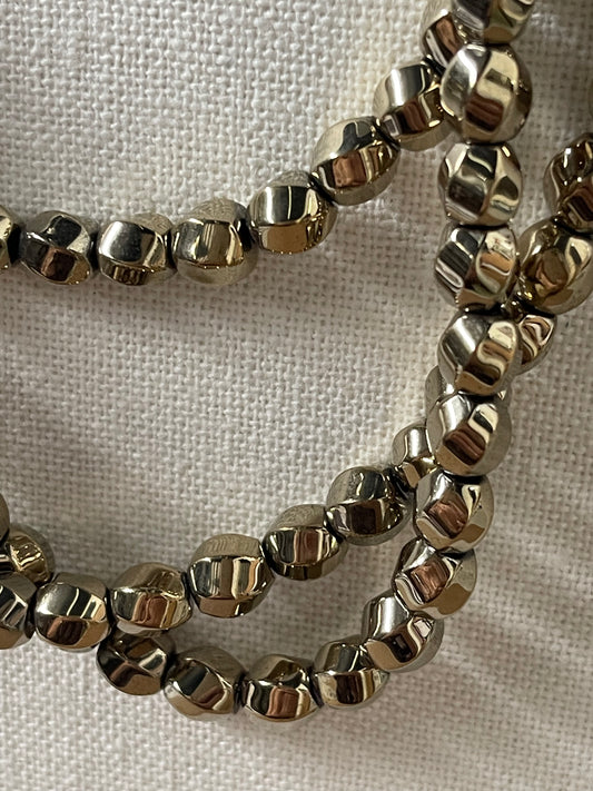 HEMATITE 8X7MM TWIST ROUND LIGHT GOLD PLATE 52 PC  PER 1 STRAND