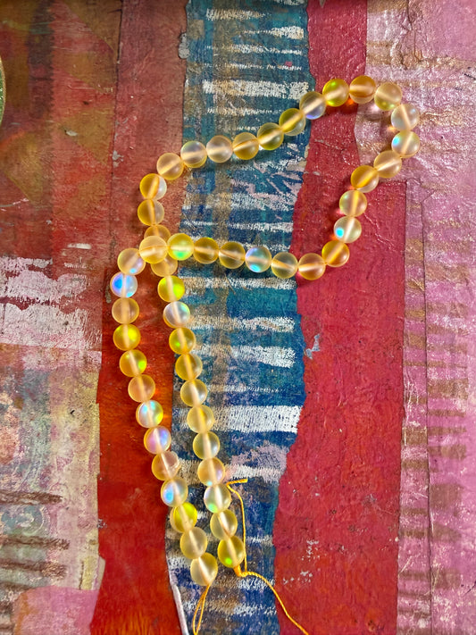 Mermaid glass 8mm round yellow ab 1 strand